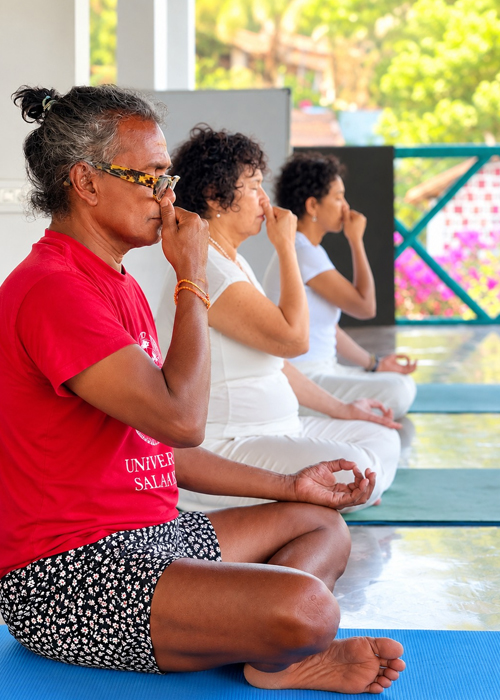 Yoga student practising Bhramari humming bee breath for calm